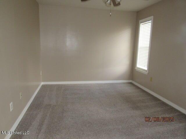 empty room with ceiling fan and carpet floors