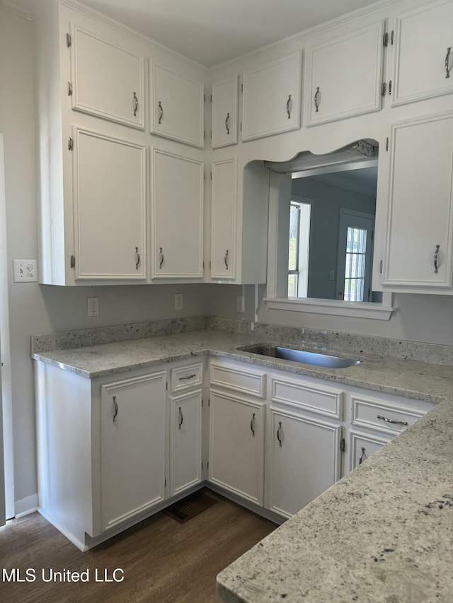 kitchen featuring white cabinetry, light countertops, and dark wood finished floors