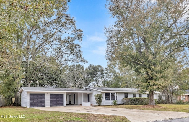 ranch-style house featuring a garage and a front lawn