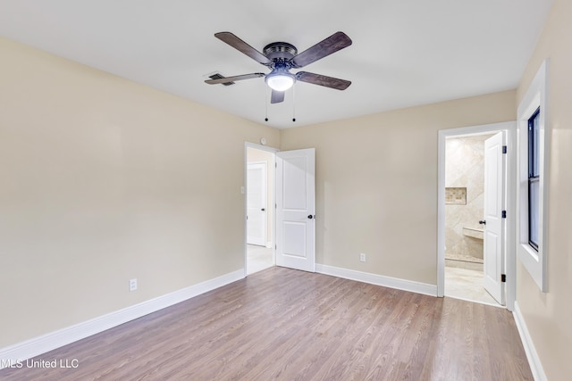 unfurnished bedroom with ensuite bathroom, ceiling fan, and light hardwood / wood-style floors