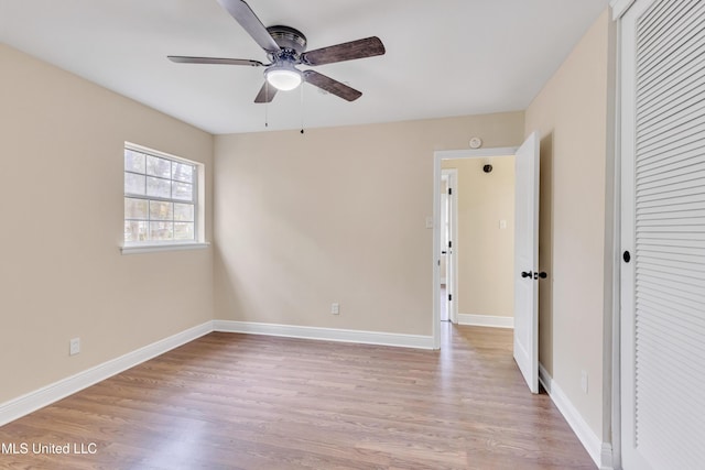 unfurnished bedroom with ceiling fan, a closet, and light wood-type flooring