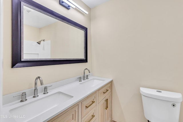 bathroom featuring a shower, vanity, and toilet