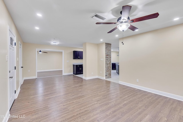 unfurnished living room with ceiling fan and light hardwood / wood-style floors