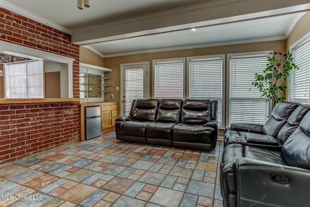 living room featuring brick wall, lofted ceiling, and ornamental molding