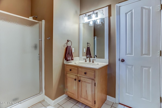 bathroom featuring vanity, tile patterned floors, and walk in shower