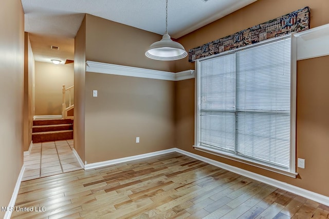 empty room with light hardwood / wood-style floors