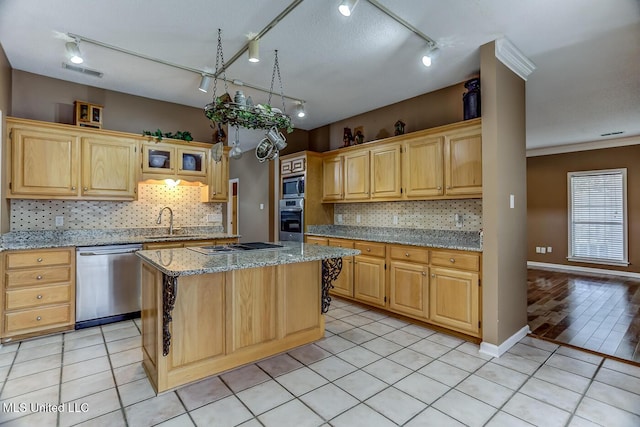 kitchen featuring light stone countertops, a center island, light tile patterned flooring, and appliances with stainless steel finishes