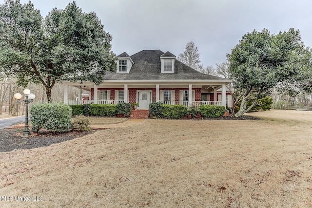 view of front of home with a porch and a front lawn