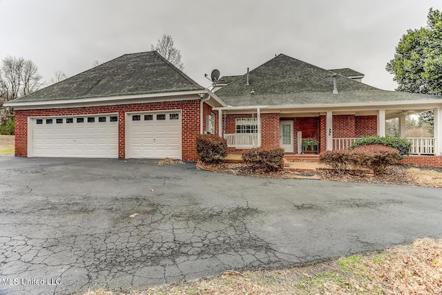 view of front of house featuring covered porch and a garage