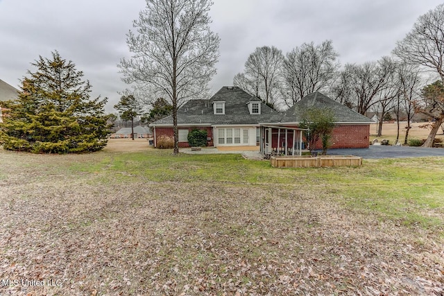 rear view of property with a yard