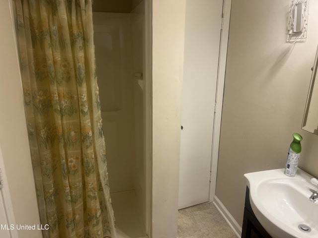 bathroom featuring curtained shower and vanity