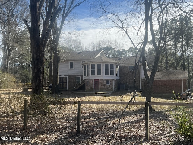 rear view of house featuring central AC