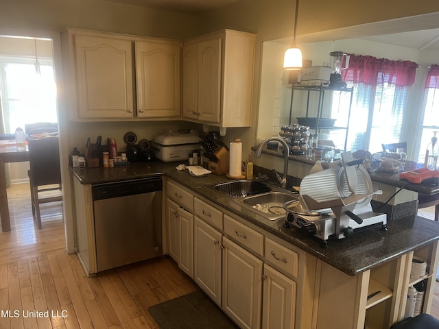 kitchen with sink, decorative light fixtures, light hardwood / wood-style flooring, and stainless steel dishwasher