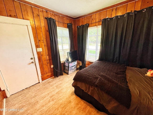340 Elm Ave, Clarksdale, MS 38614 - bedroom with wood walls and light wood-type flooring