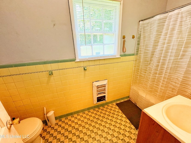 340 Elm Ave, Clarksdale, MS 38614 - full bathroom with tile walls, a wainscoted wall, plenty of natural light, vanity, and tile patterned floors