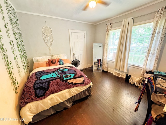 340 Elm Ave, Clarksdale, MS 38614 - bedroom with dark wood finished floors, crown molding, ceiling fan, and baseboards