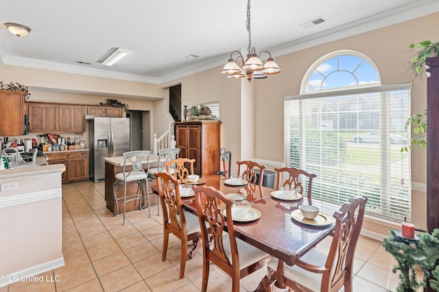 8436 Ansley Park Ln, Southaven, MS 38672 - dining area featuring stairs, light tile patterned floors, ornamental molding, and a chandelier