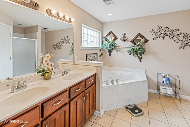 8436 Ansley Park Ln, Southaven, MS 38672 - bathroom featuring a stall shower, double vanity, a garden tub, and tile patterned flooring