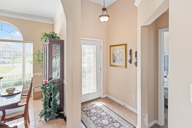 8436 Ansley Park Ln, Southaven, MS 38672 - foyer featuring light tile patterned floors, ornamental molding, and arched walkways
