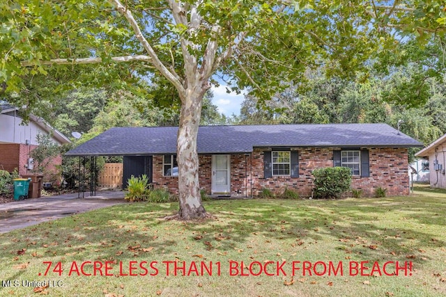 216 Buena Vista Dr, Long Beach, MS 39560 - ranch-style house featuring a front lawn, a shingled roof, an attached carport, driveway, and brick siding