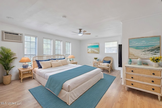 216 Buena Vista Dr, Long Beach, MS 39560 - bedroom with light wood finished floors, ceiling fan, an AC wall unit, and multiple windows