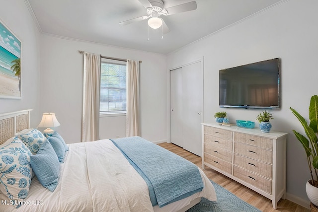 216 Buena Vista Dr, Long Beach, MS 39560 - bedroom featuring a closet, ornamental molding, baseboards, light wood-type flooring, and a ceiling fan