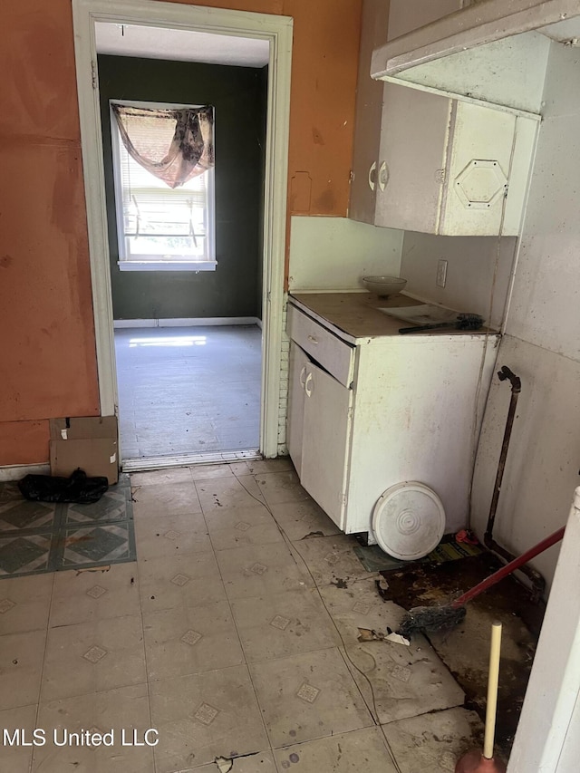 731 Hillmont Dr, Jackson, MS 39209 - kitchen with dark countertops, white cabinets, and extractor fan