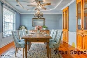dining space featuring plenty of natural light, coffered ceiling, wood finished floors, crown molding, and ceiling fan