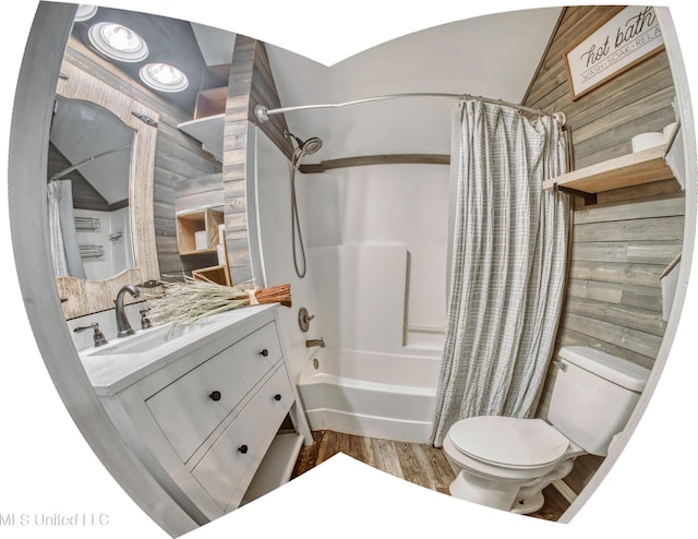 bathroom with toilet, shower / bathtub combination with curtain, vanity, and wood finished floors