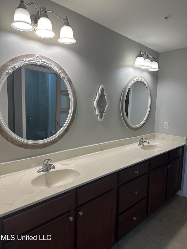 bathroom with double vanity, a sink, and tile patterned floors