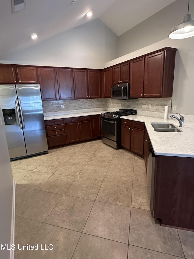 kitchen with light tile patterned floors, stainless steel appliances, light countertops, visible vents, and a sink