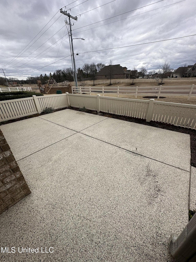 view of patio featuring fence