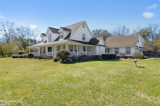 view of front of home with covered porch, a front lawn, and a garage