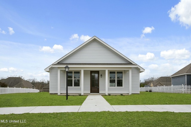 view of front of house with a front yard, covered porch, and fence