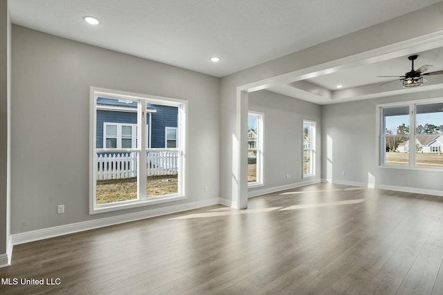 unfurnished room with baseboards, wood finished floors, and recessed lighting