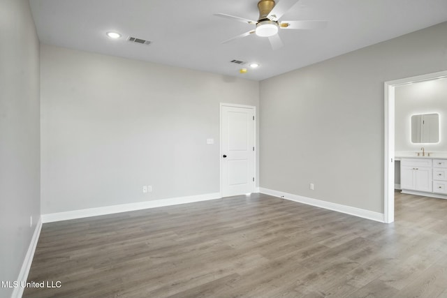 unfurnished bedroom featuring baseboards, visible vents, wood finished floors, and recessed lighting