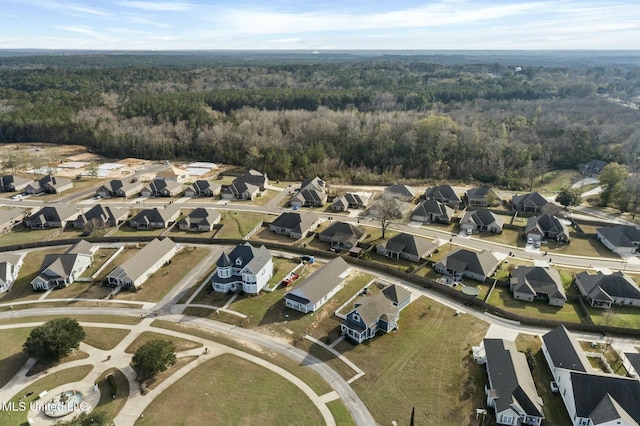 aerial view with a wooded view and a residential view