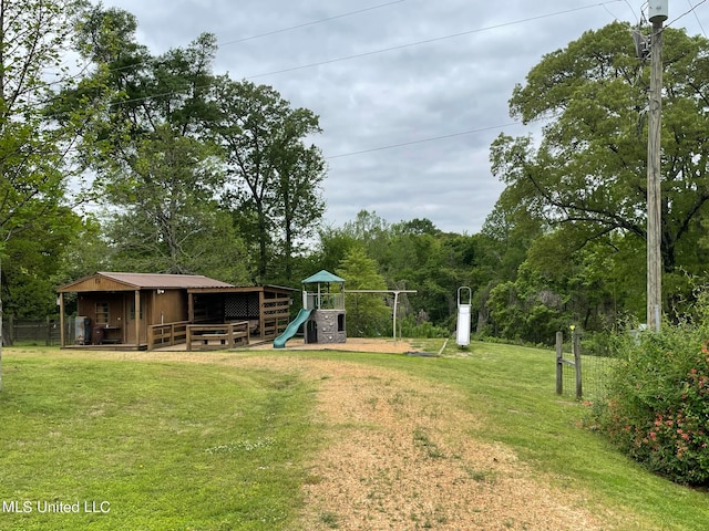 view of yard with a playground and an outbuilding