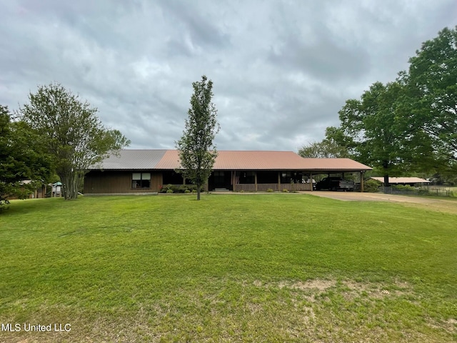 ranch-style house featuring a carport and a front lawn