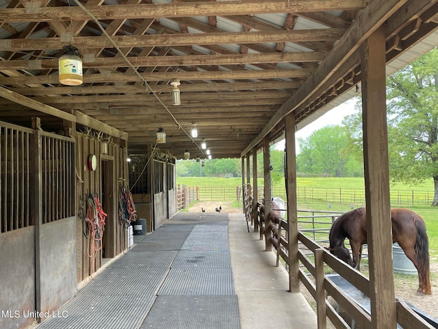 view of stable with a rural view