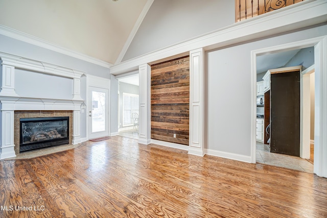 9480 Miranda Dr, Olive Branch, MS 38654 - unfurnished living room with high vaulted ceiling, wood finished floors, a tile fireplace, and ornamental molding