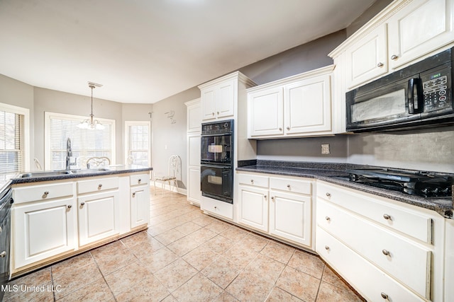 9480 Miranda Dr, Olive Branch, MS 38654 - kitchen with black appliances, dark countertops, and white cabinets