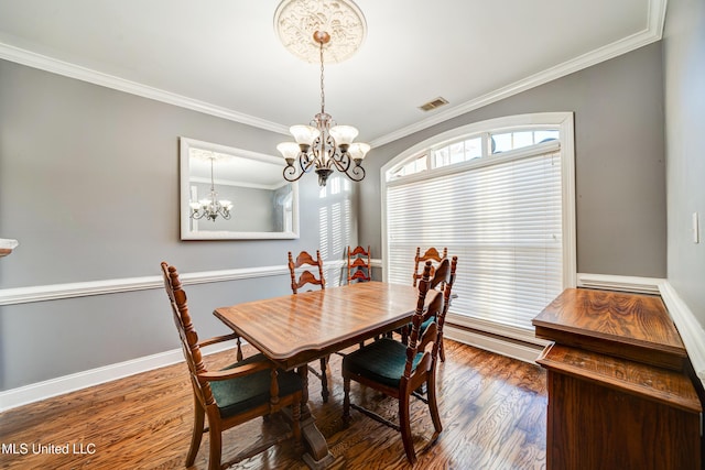 9480 Miranda Dr, Olive Branch, MS 38654 - dining area with crown molding, a chandelier, and wood finished floors