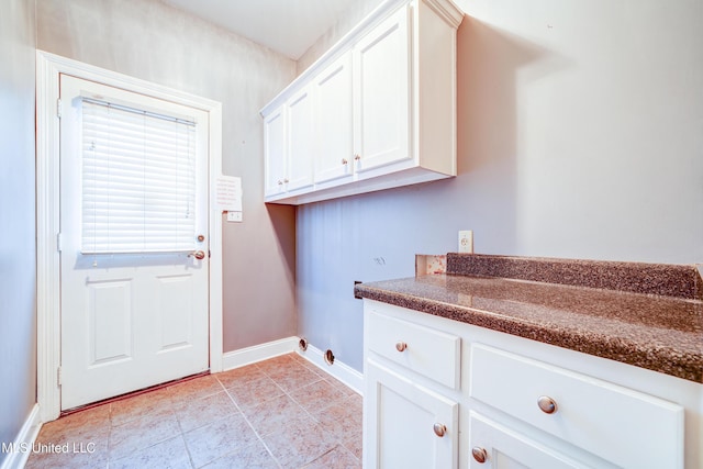 9480 Miranda Dr, Olive Branch, MS 38654 - washroom featuring washer hookup, cabinet space, and light tile patterned floors