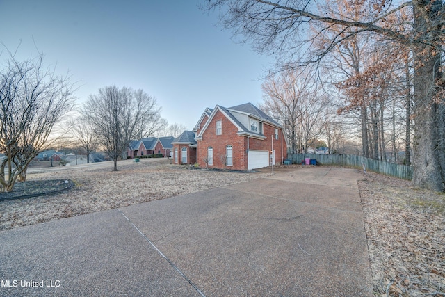 9480 Miranda Dr, Olive Branch, MS 38654 - view of side of property featuring brick siding, driveway, and an attached garage