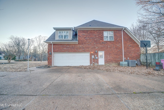 9480 Miranda Dr, Olive Branch, MS 38654 - view of side of home with a garage, concrete driveway, brick siding, and a shingled roof