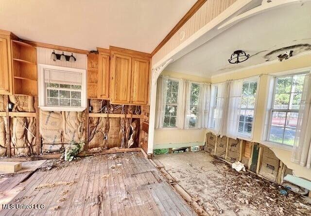 interior space with wood-type flooring and crown molding