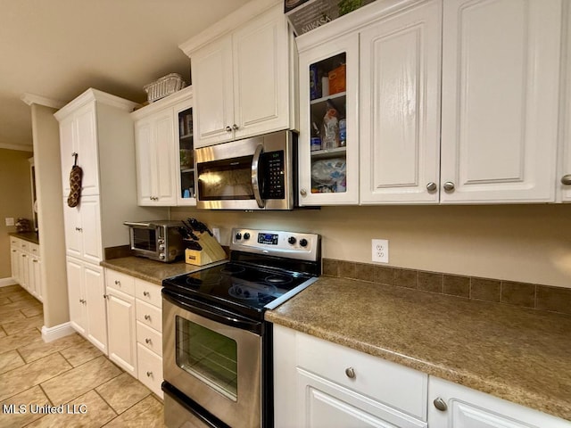 kitchen featuring stainless steel appliances and white cabinetry