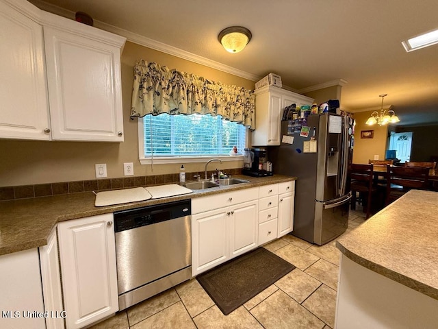 kitchen featuring an inviting chandelier, crown molding, sink, appliances with stainless steel finishes, and white cabinetry