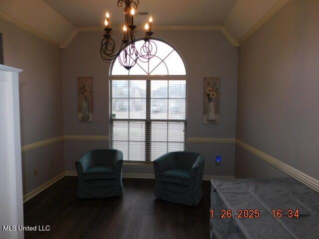 sitting room featuring crown molding, lofted ceiling, dark hardwood / wood-style floors, and a chandelier